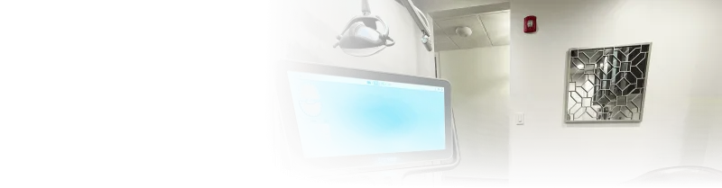 A computer monitor with a glass mirror on the wall