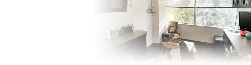 A dentists exam room with a large mirror
