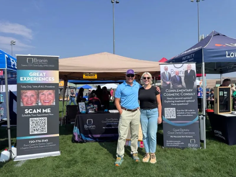 Superior dentist standing at booth at chili fest