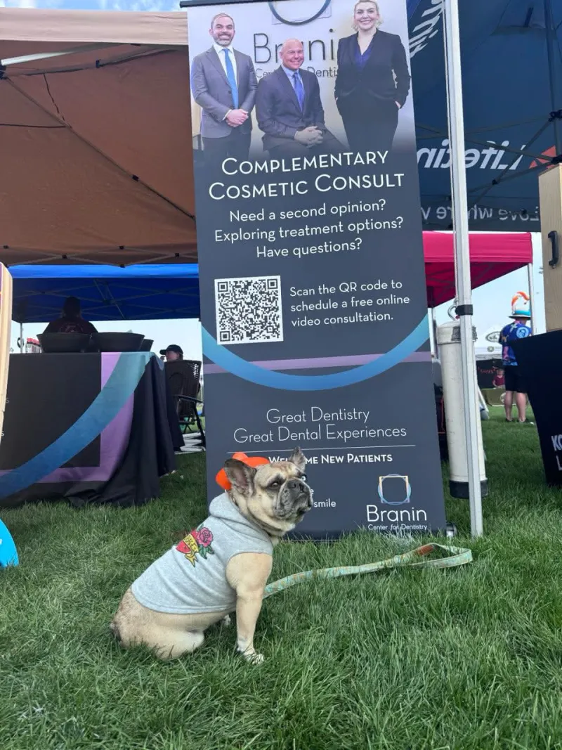 Dog in a shirt at a booth at chili fest