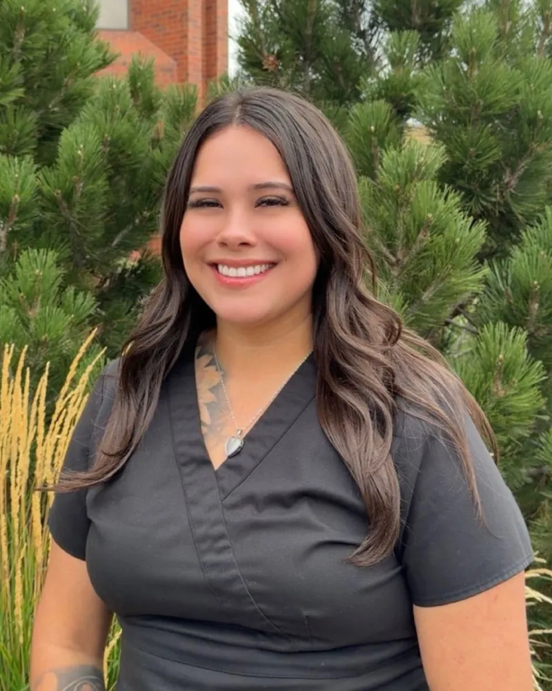 A photo of Julia Hernandez smiling outside.