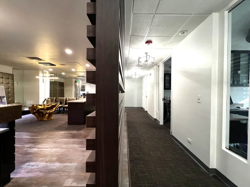 A view of a hallway and lobby with front desk