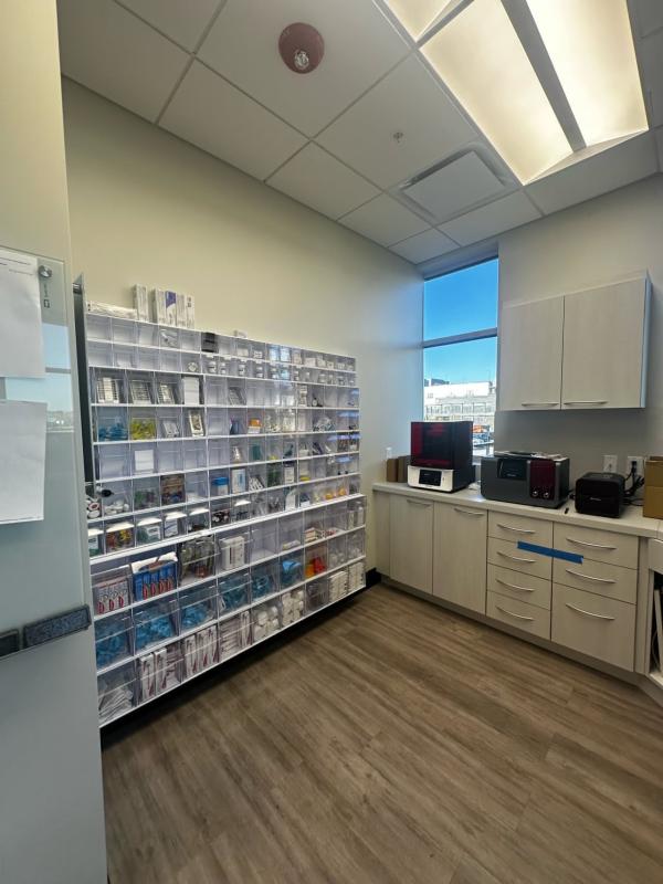 A white shelving unit stocked with medicine